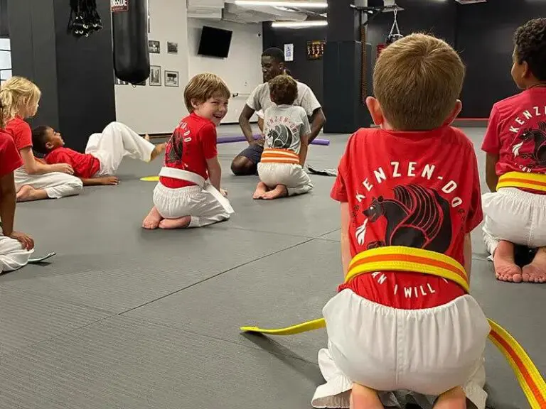 Children listen to an instructor during group taekwondo basics for preschoolers