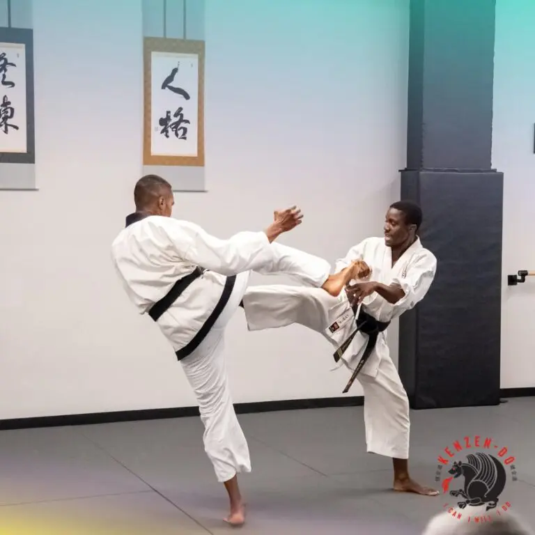 Two black belts practice controlled kicks during taekwondo distance training